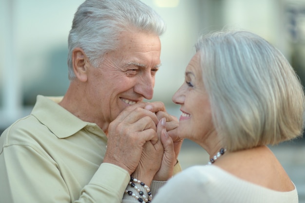 Happy nice mature couple walking in town