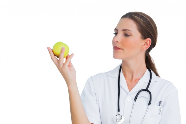 Happy nurse holding an apple