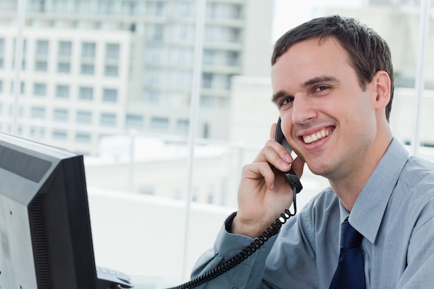 Happy office worker on the phone