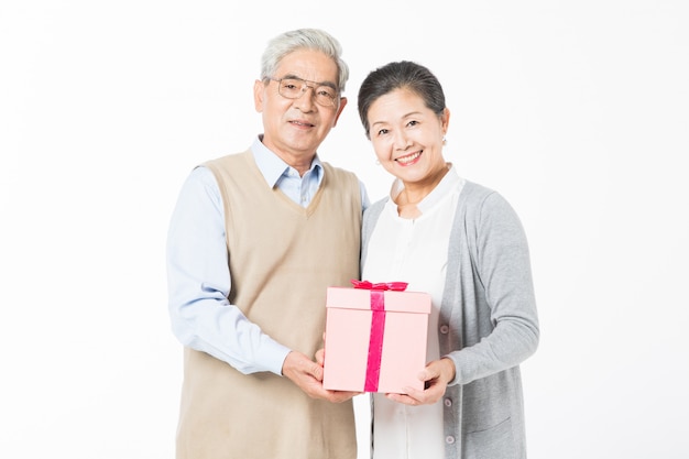 Happy old couples with gift boxes