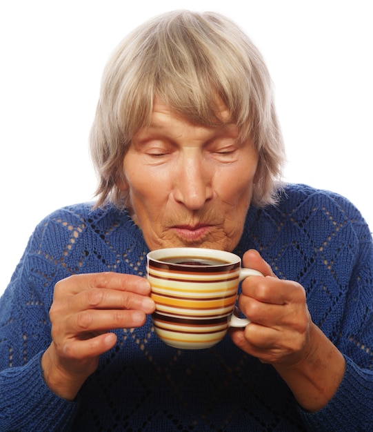 Happy old lady with coffee, isolated on white