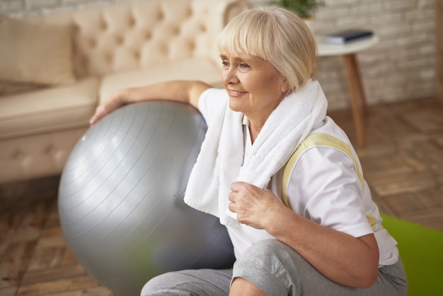 Happy Old Lady with Fit Ball Workout Recovery.