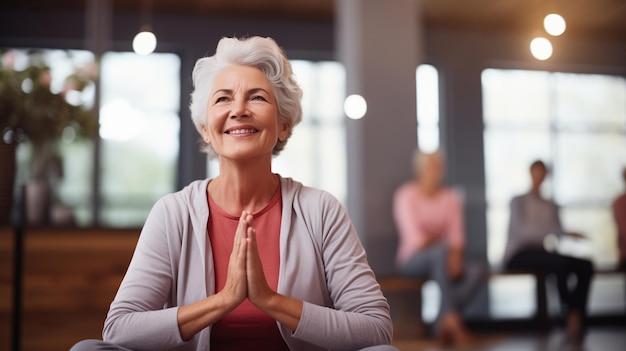 happy old pretty woman doing yoga in yoga class