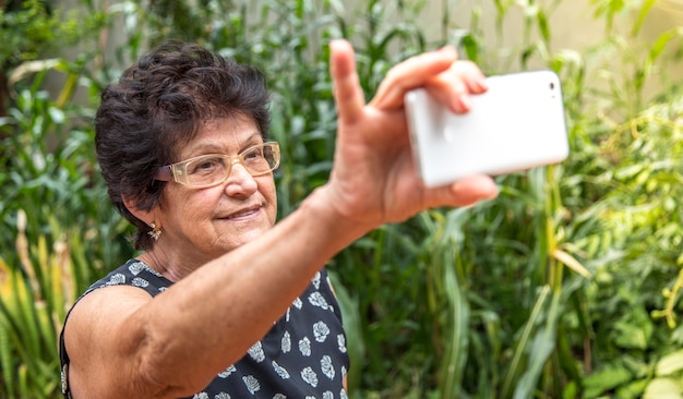 Happy old woman pulling self