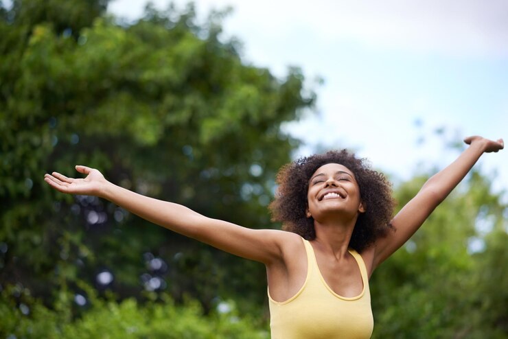 Photo happy open arms and black woman in park for freedom adventure and relax in nature smile excited and person with happiness positive attitude and fun outdoors for holiday vacation and weekend