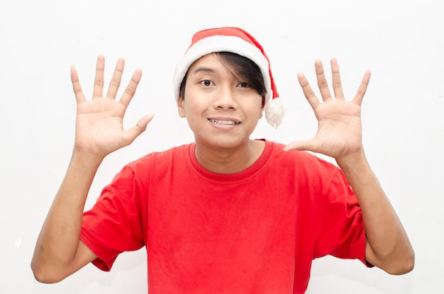 happy overjoy estactic attractive Asian man in red Christmas theme clothes isolated over white.