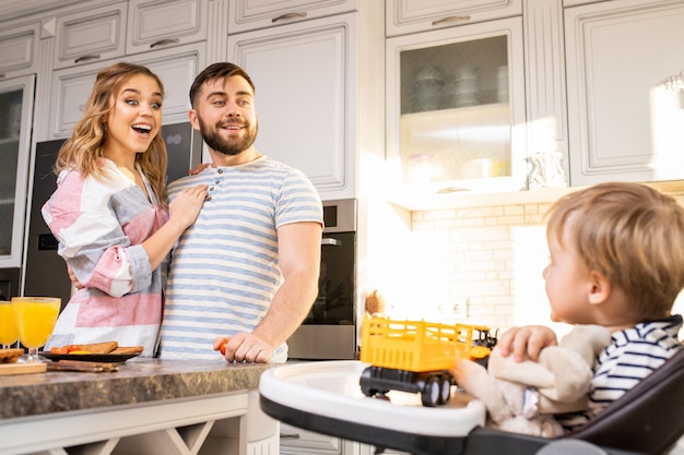 Happy Parents Looking at Baby