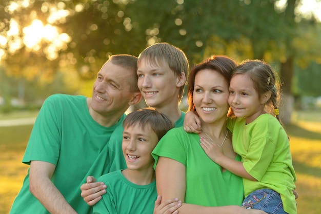 Happy parents with their children at sunset