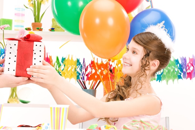 happy party girl with balloons and gift box