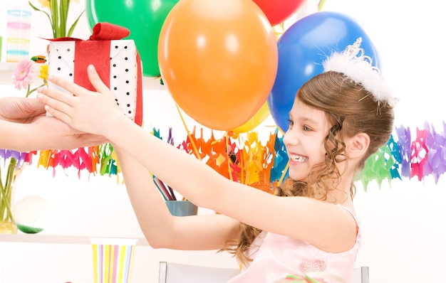 happy party girl with balloons and gift box