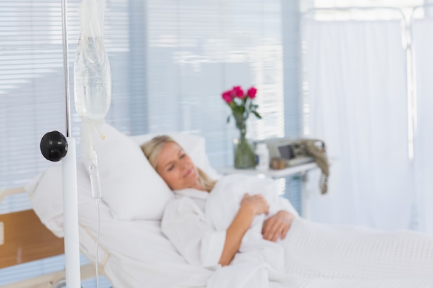 Happy patient lying on her bed 