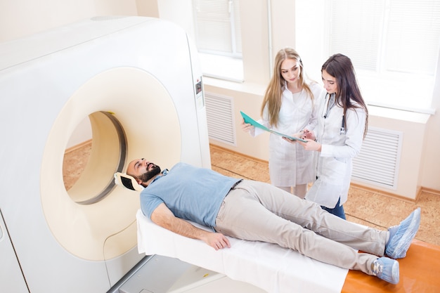 Happy patient undergoing mri scan at hospital.