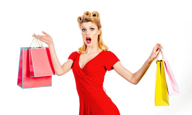 Happy pinup woman with shop bags. Big sales concept. Pretty lady shopaholic.