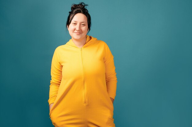 Happy plus size positive woman. Happy body positive concept. I love my body. Attractive overweight woman dressed in a yellow suit fun posing for the camera