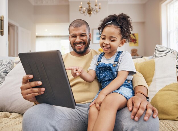 Happy pointing and a child with a father and tablet for a cartoon movie and streaming games smile family and a dad with a girl kid and gesture to technology for a show or social media in a house