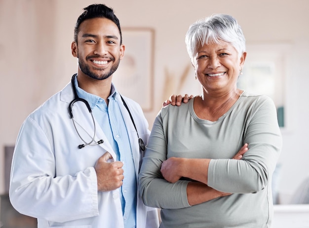 Happy portrait doctor and senior patient for healthcare retirement wellness and hospital service Smile face and Biracial elderly woman with medical professional worker or asian person for health