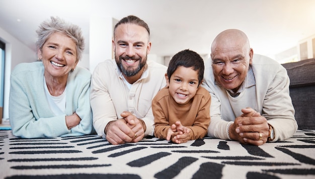 happy portrait and family on the floor for bonding playing and quality time smile happiness and father child and grandparents lying on the living room during a visit together in a house