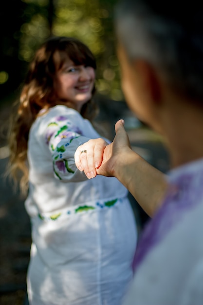 Happy portrait of loving couple on a walk in the park on a sunny day