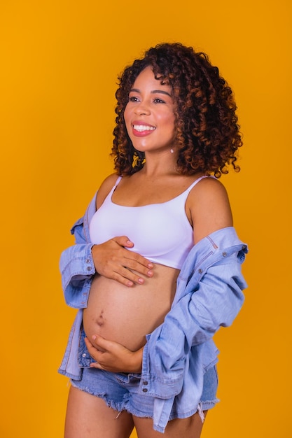 Happy pregnant afro woman waiting for baby