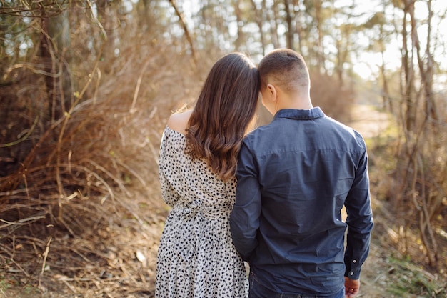 Happy pregnant couple in nature