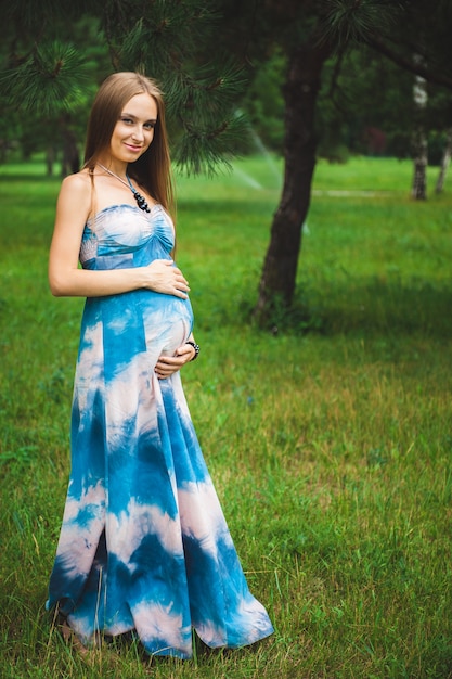 Happy pregnant Couple in the summer park