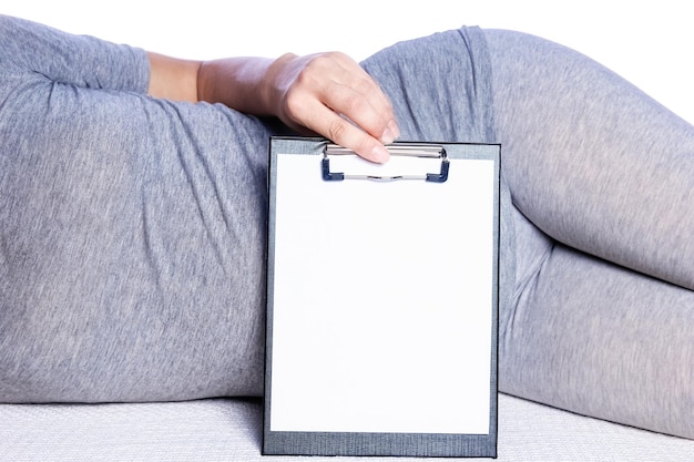 Happy pregnant girl lies on white background