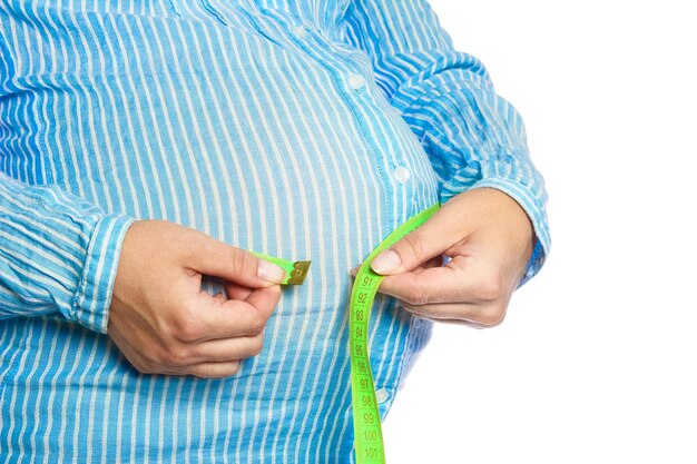 Happy pregnant girl lies on white background