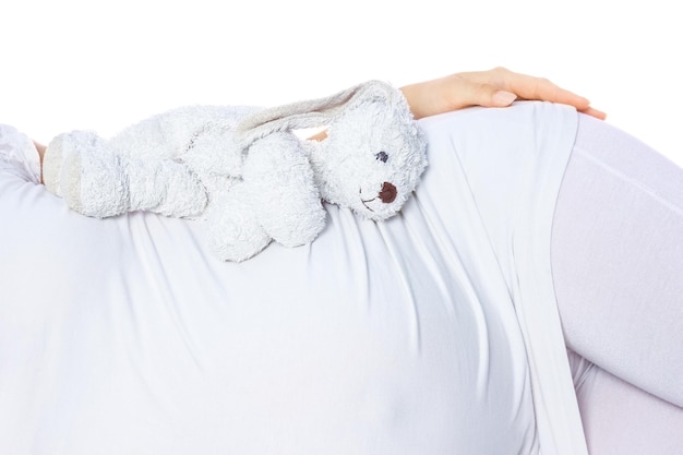 Happy pregnant girl lies on white background