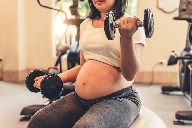 Happy pregnant woman and expecting baby.