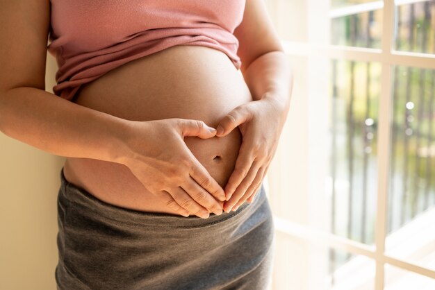 Happy pregnant woman and expecting baby.