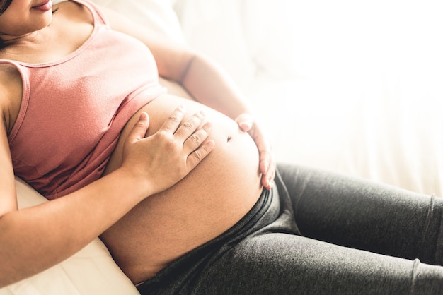 Happy pregnant woman and expecting baby.