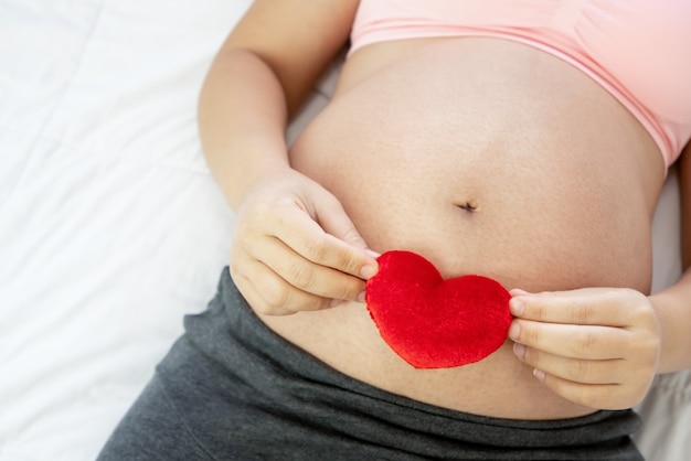 Happy pregnant woman and expecting baby.