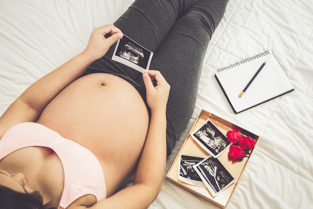 Happy pregnant woman and expecting baby.