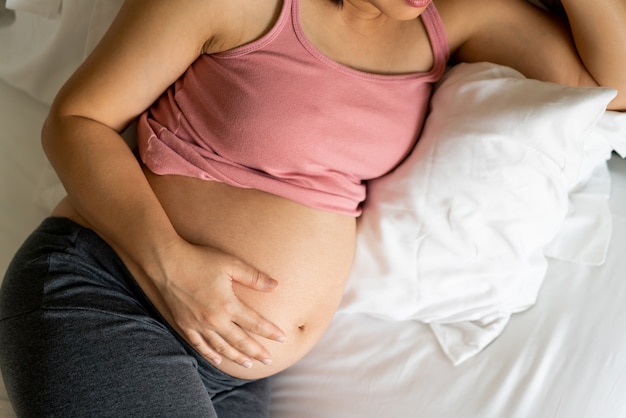 Happy pregnant woman and expecting baby.