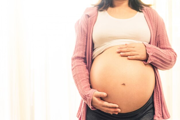 Happy pregnant woman and expecting baby.