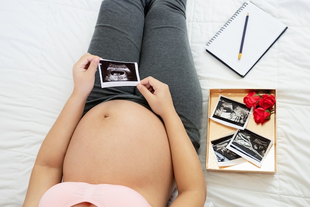 Happy pregnant woman and expecting baby.