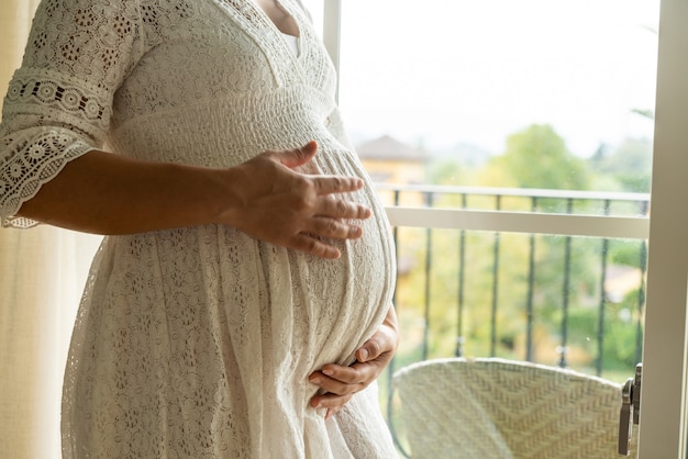 Happy pregnant woman and expecting baby.