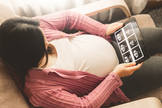 Happy pregnant woman and expecting baby.