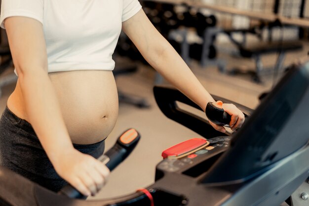 Happy pregnant woman making sport