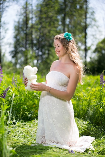 Happy pregnant woman relaxing and enjoying life in nature