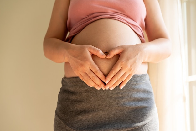 Happy pregnant woman with baby in pregnant belly