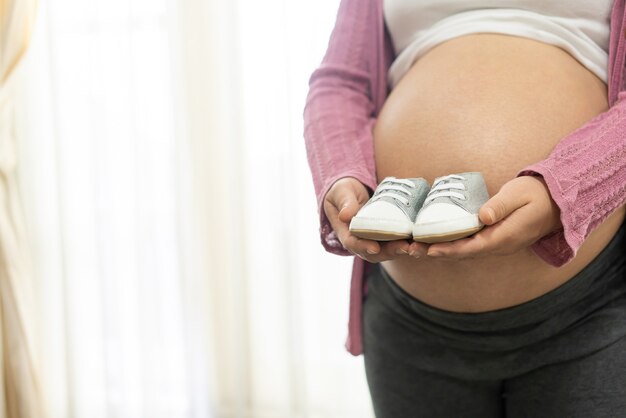 Happy pregnant woman with baby in pregnant belly.