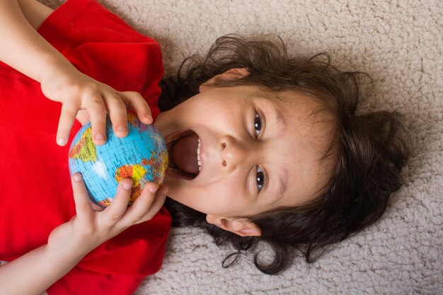 Happy preschooler boy discovering world as back to school concept