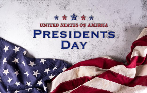 Happy presidents day concept with flag of the United States and the text on dark stone background