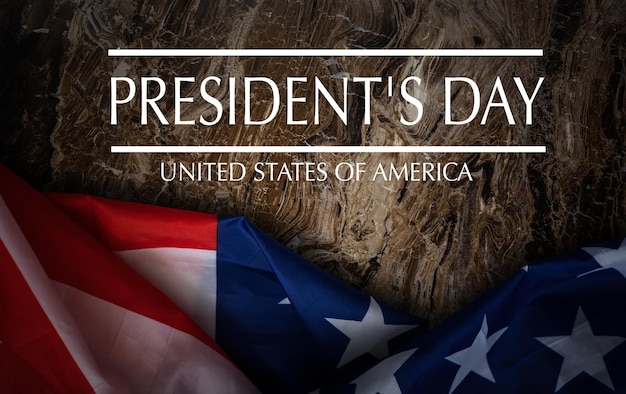 Happy presidents day concept with vintage flag of the united states on old stone background