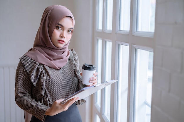 Happy professional arab businesswoman brown hijab working at home.