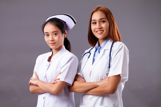 Happy professional female doctor and nurse, medical team, health care worker