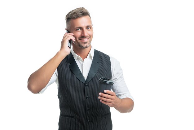 Happy professional guy talking on mobile phone during tea break isolated on white