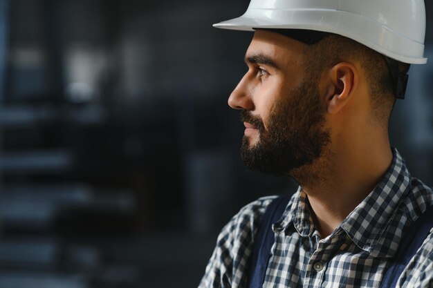 Happy Professional Heavy Industry Engineer Worker Wearing Uniform and Hard Hat in a Steel Factory Smiling Industrial Specialist Standing in a Metal Construction Manufacture