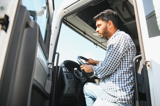 Happy professional truck driver driving his truck Copy space